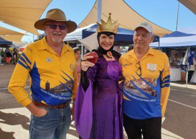 Team members with a person dressed as evil queen from Snow White